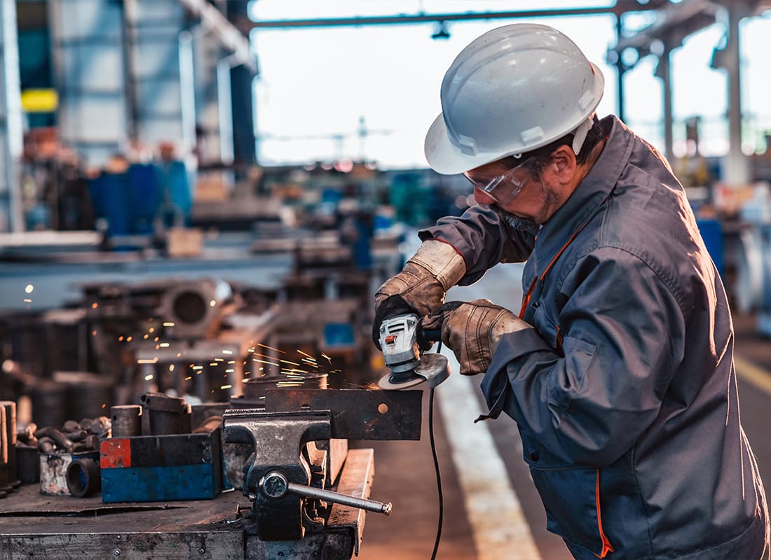 Insurance by Industry - Skilled Industrial Worker Grinding Metal Part